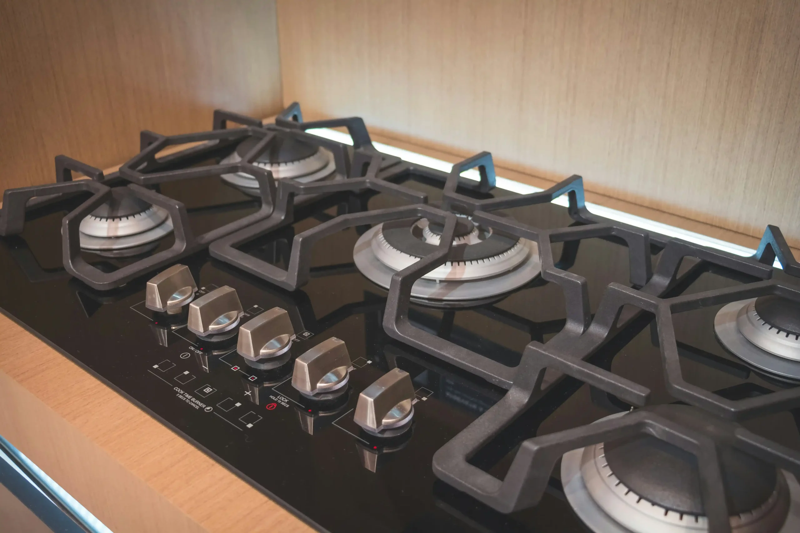 Five-burner gas cooktop with cast iron grates in a Lexington KY home