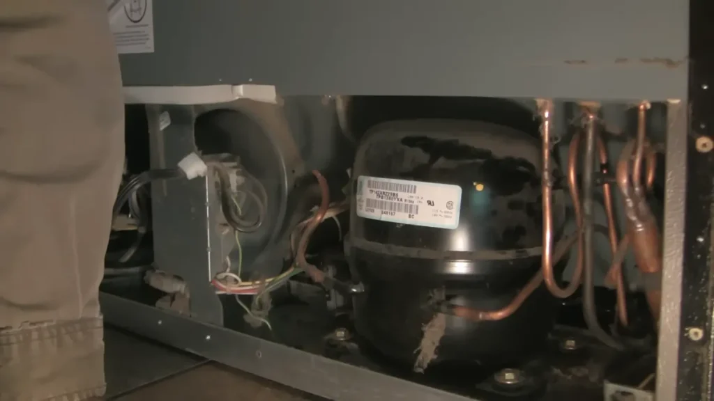 Refrigerator compressor and evaporator fan exposed during repair diagnostic in Lexington KY