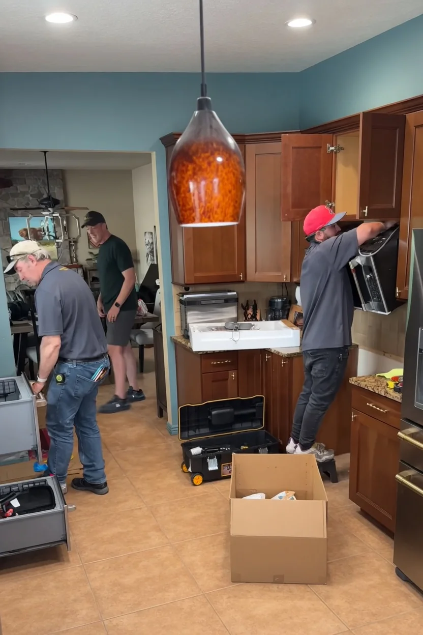 Local Lexington KY appliance repair technicians installing a built-in microwave in a residential kitchen